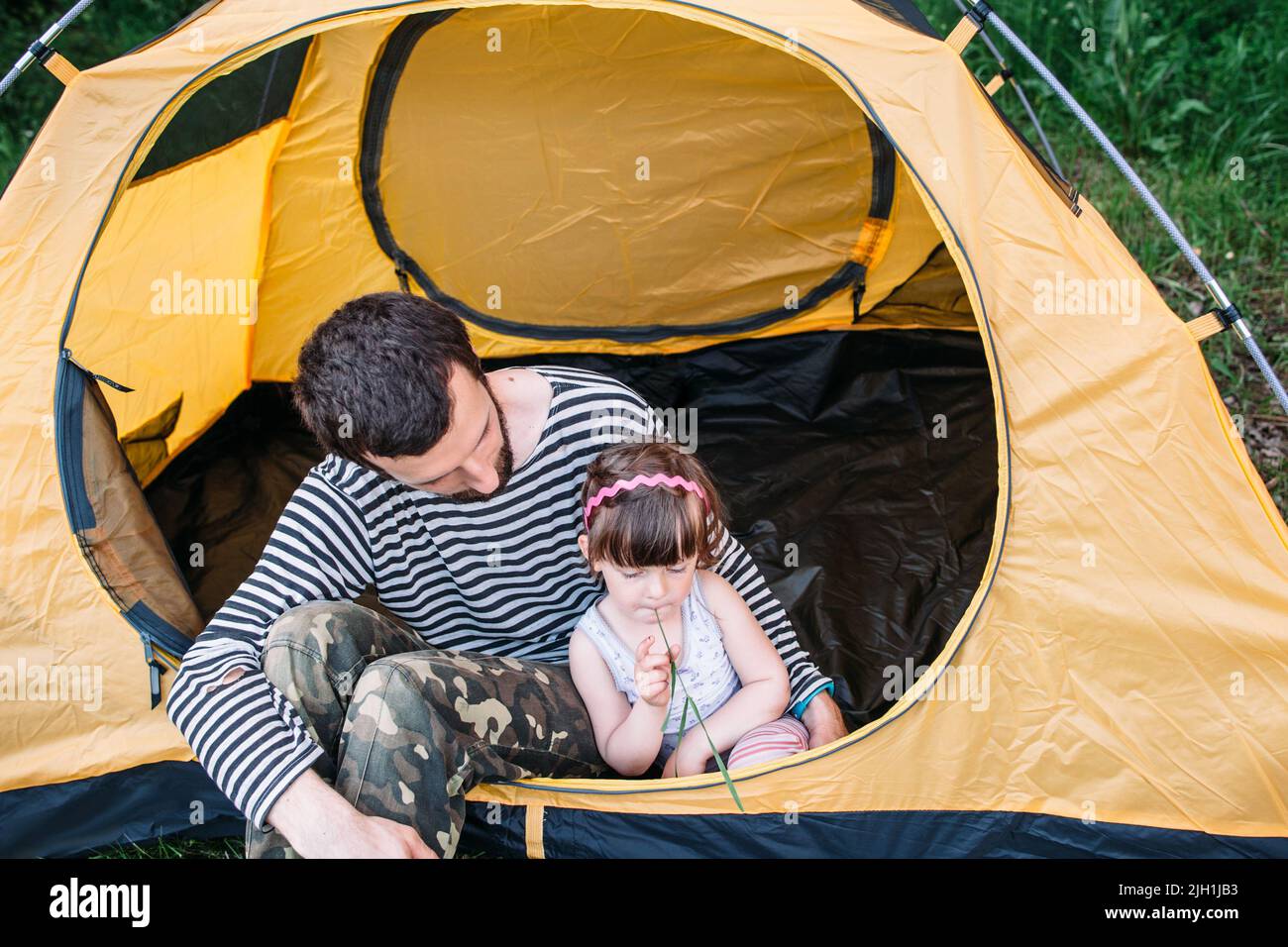 Dad with his little daughter in tent on camping Stock Photo - Alamy