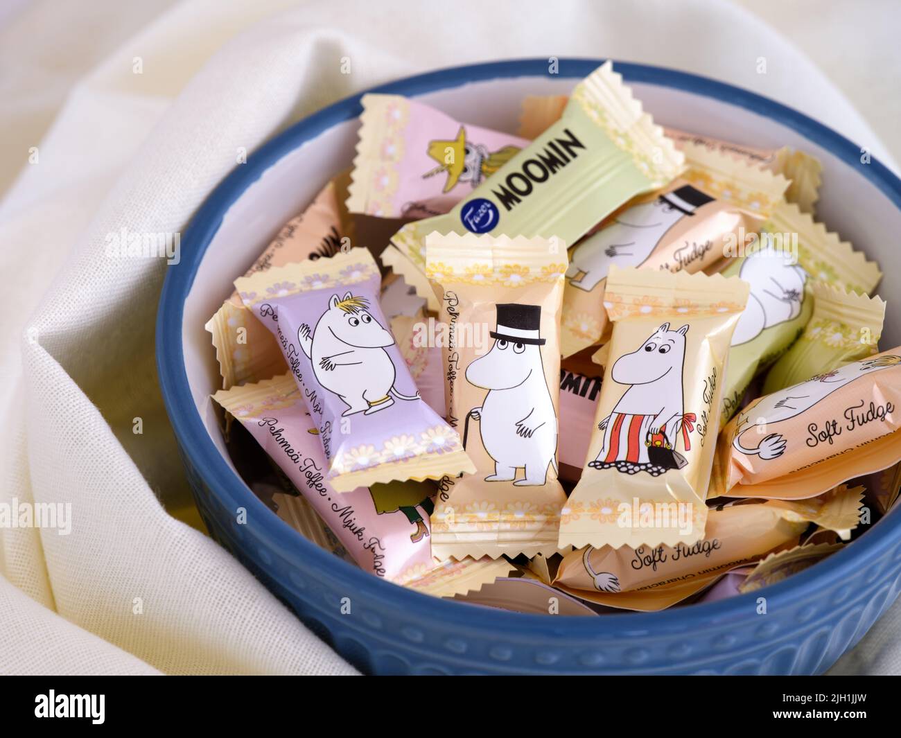 Tambov, Russian Federation - April 27, 2022 A Bowl full of Moomin Soft fudge candies by Fazer. The fudge comes single wrapped, with 9 different charac Stock Photo