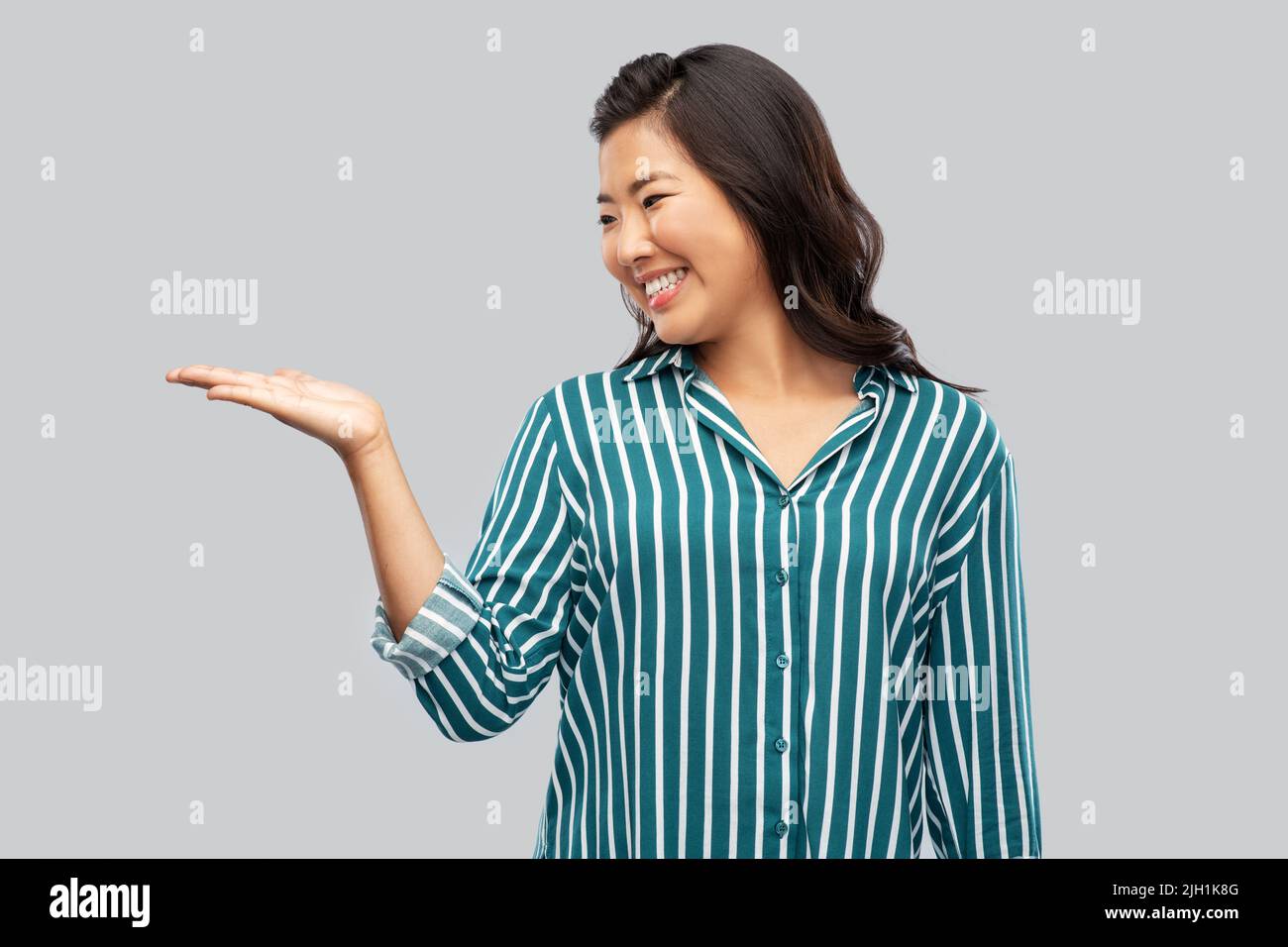 Happy young asian woman presenting hi-res stock photography and images ...