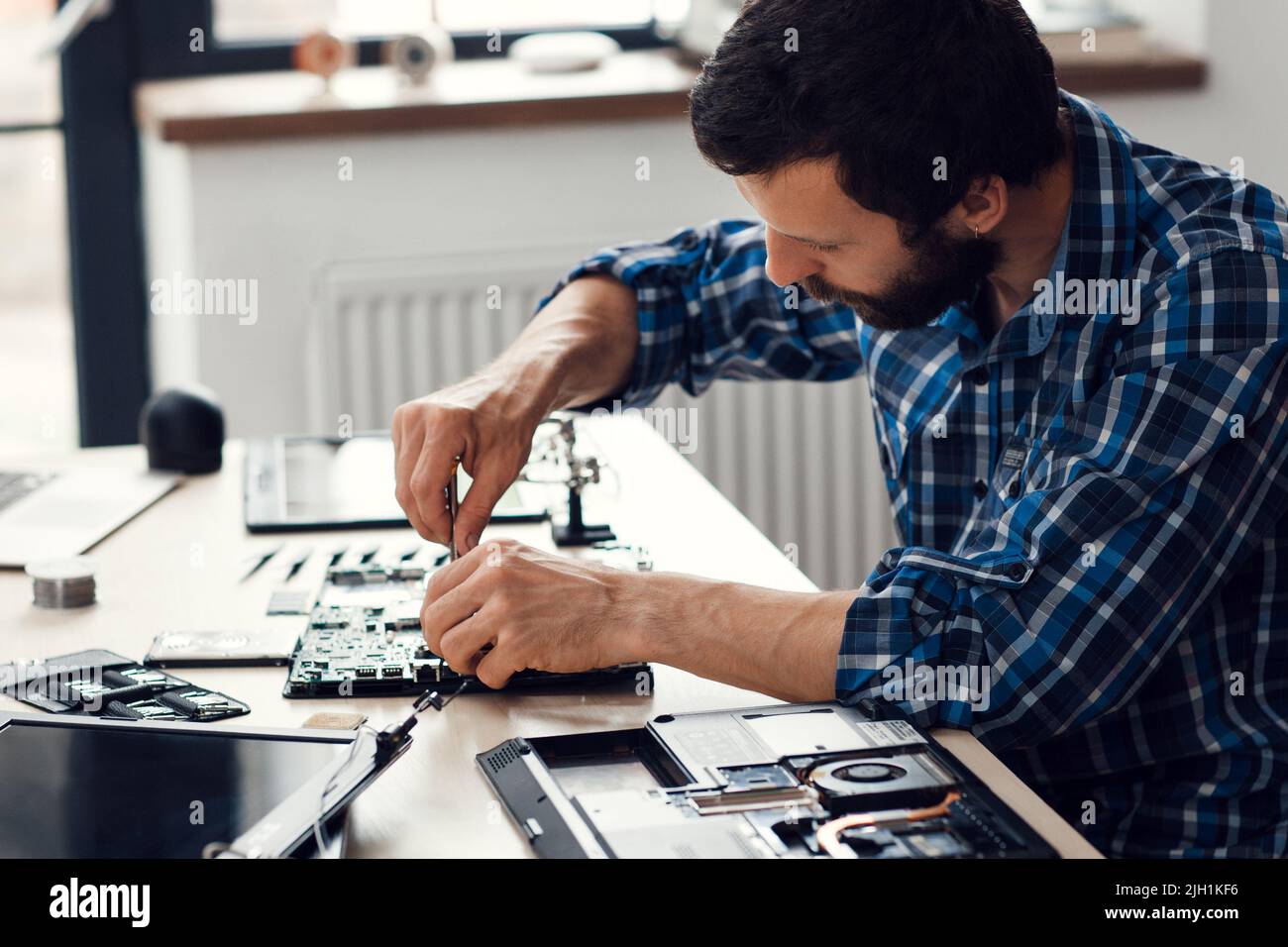 Laptop disassembling with screwdriver, side view Stock Photo - Alamy
