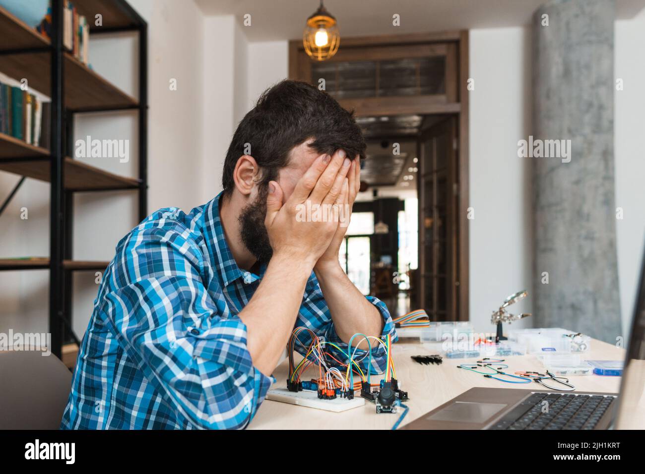 Engineer closed his face in despair, free space Stock Photo