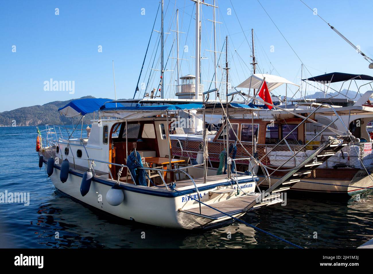 Pleasure yacht in the port. Tourist ship with people on board with ...