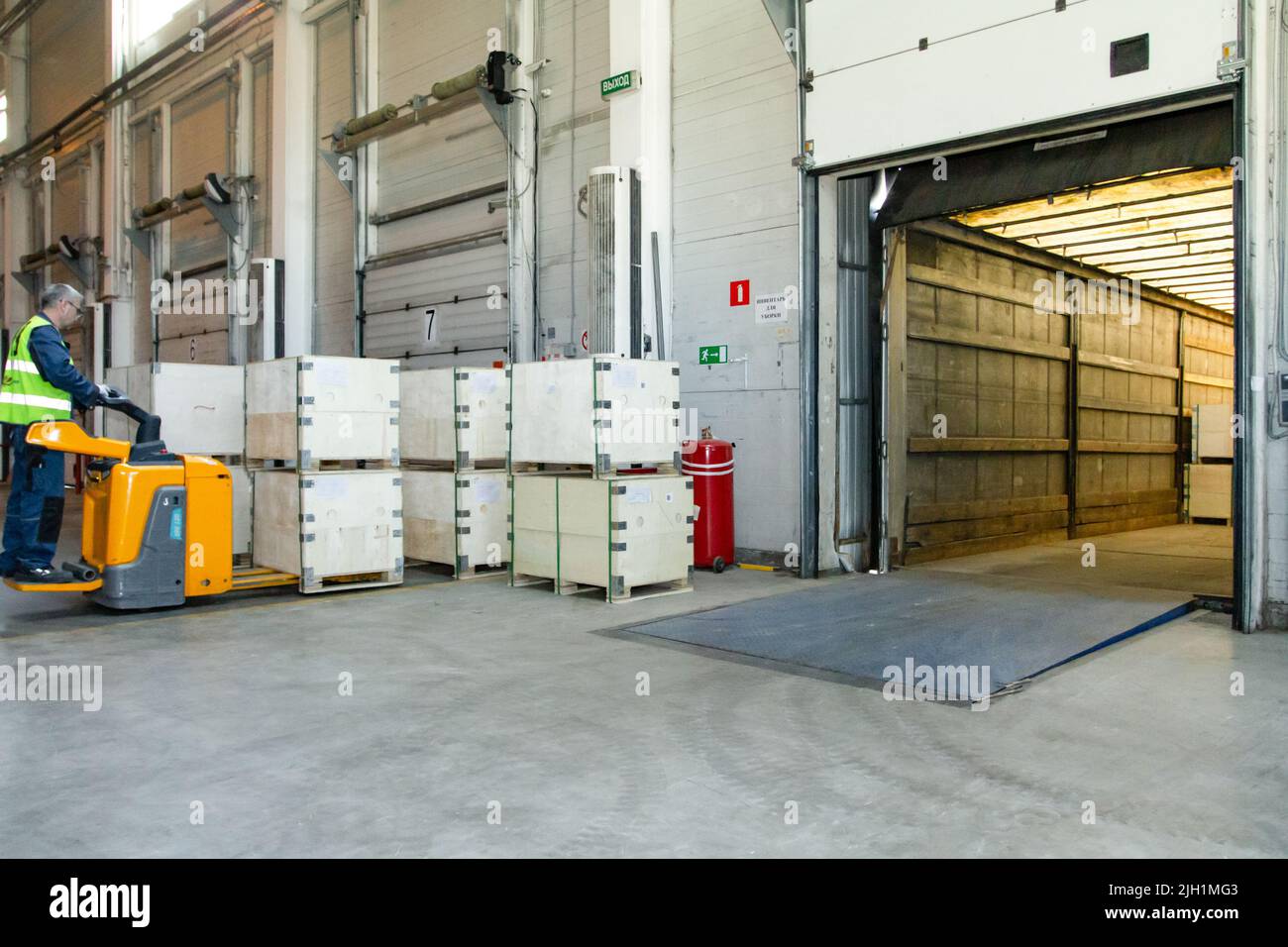 Interior of a modern warehouse storage of retail shop with pallet truck ...