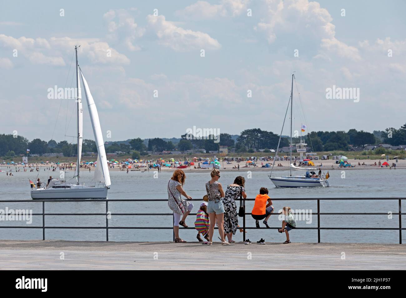 Family looking at Priwall Beach across River Trave, sailing boats, Travemünde, Lübeck, Schleswig-Holstein, Germany Stock Photo