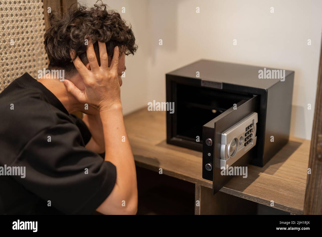 The unrecognizable man was shocked when opening a blank safe box Stock ...