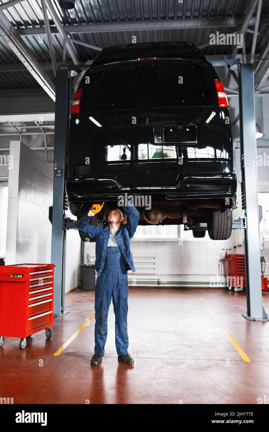 Mechanic working with car suspension system Stock Photo Alamy