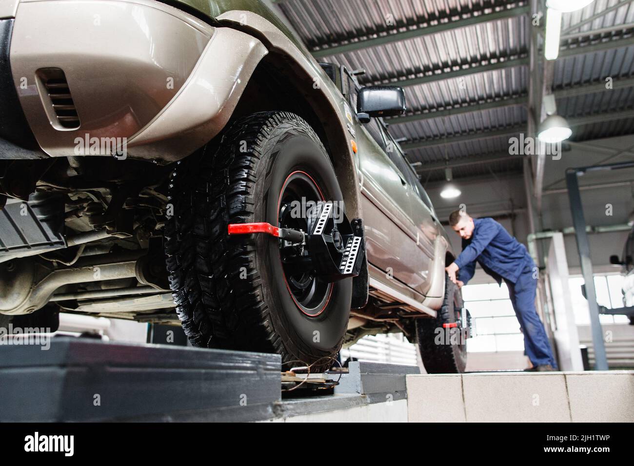 Tire clamped with aligner for auto wheel alignment Stock Photo