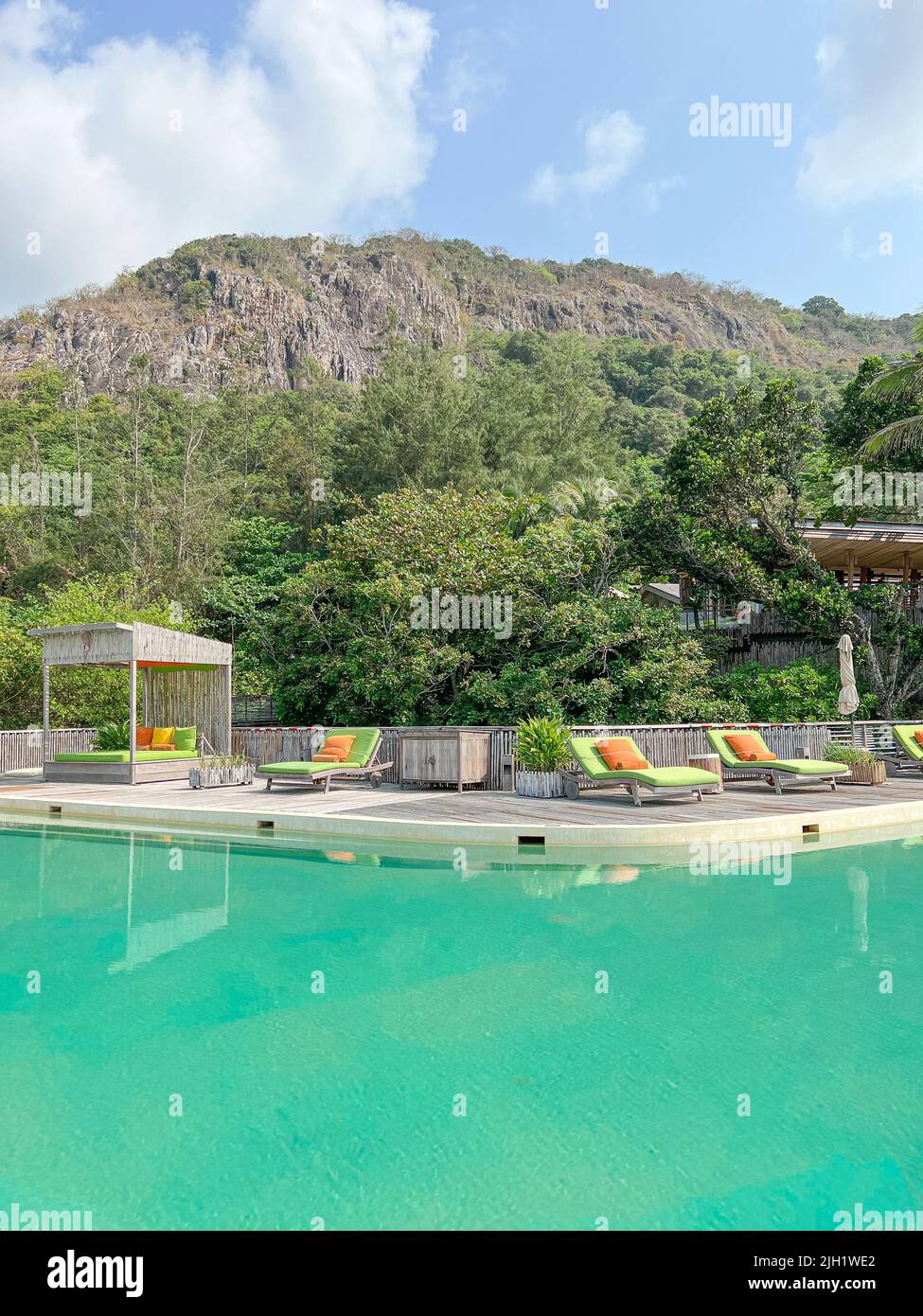 Umbrella and chair around swimming pool in hotel and resort Holiday
