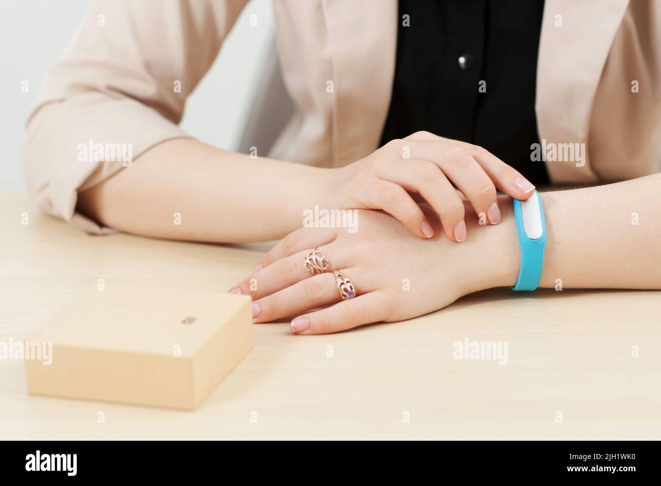 Unrecognizable woman try on blue fitness bracelet Stock Photo