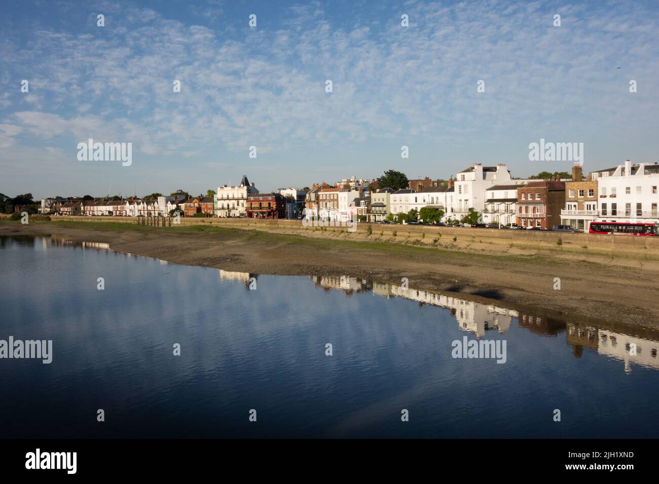 A dappled sky and reflections on the River Thames on the Terrace at Barnes, southwest London, England, UK Stock Photo