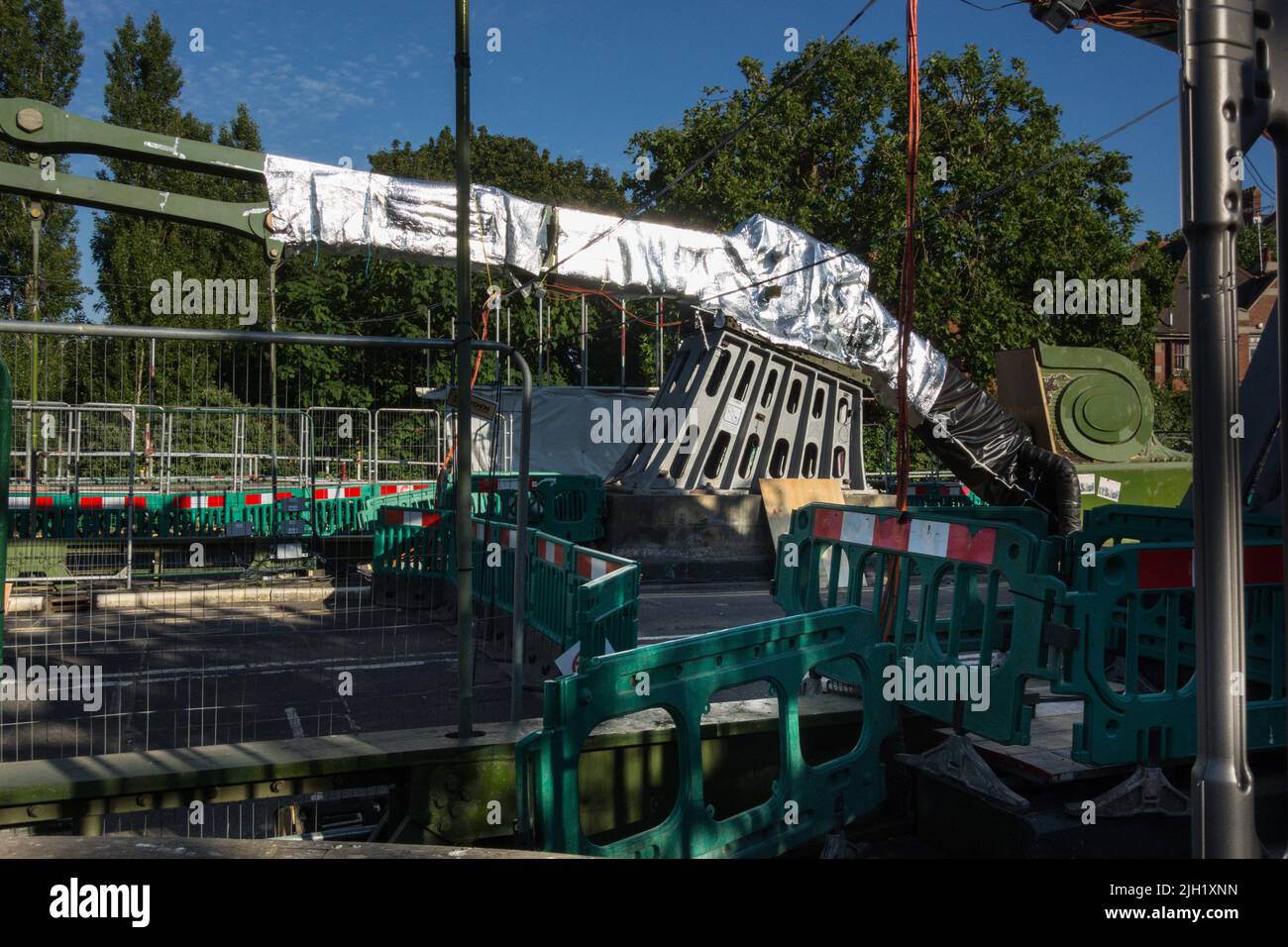 Closeup of Hammersmith Bridge swathed in silver insulation and aluminum foil to protect it from the sun and heatwave in London, England, UK Stock Photo