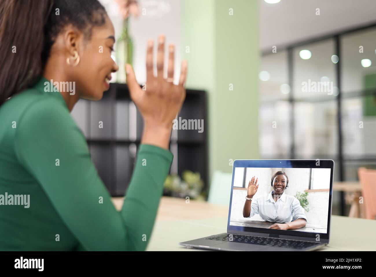 Female freelancer, student, colleague using laptop for virtual meeting ...
