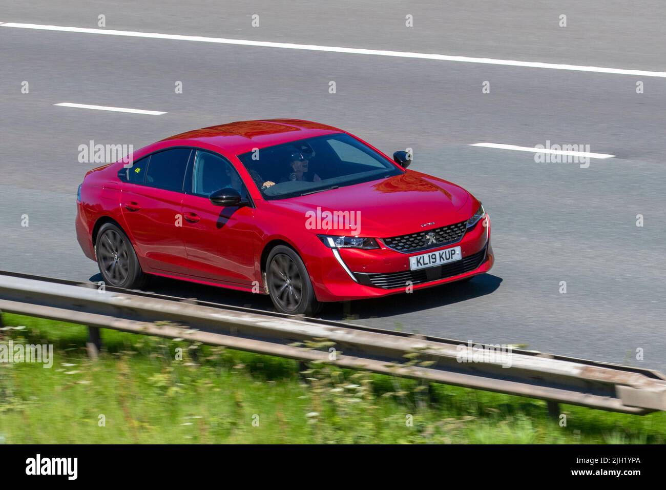 2019 red PEUGEOT 508 BLUEHDI S/S GT LINE 2000cc Diesel 8 speed automatic; travelling on the M6 Motorway, Manchester, UK Stock Photo