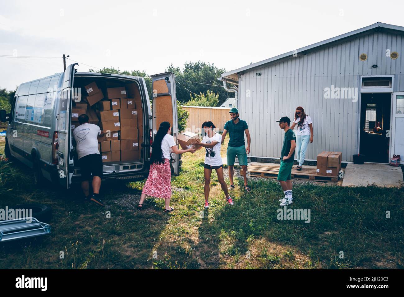 Volunteers unload pets food aid for animals from Europe for volunteers
