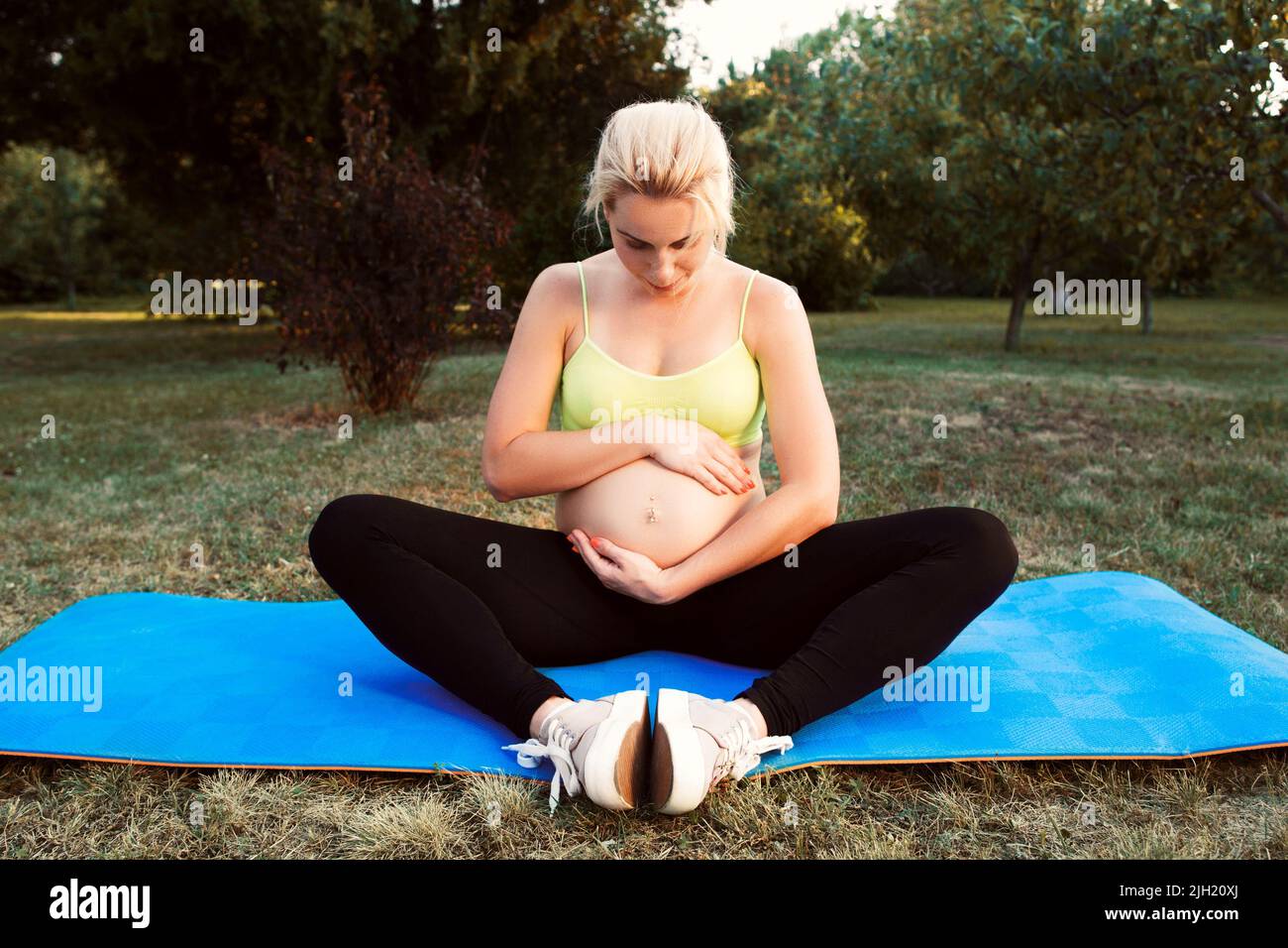 Pregnant woman hugging her belly, free space Stock Photo - Alamy