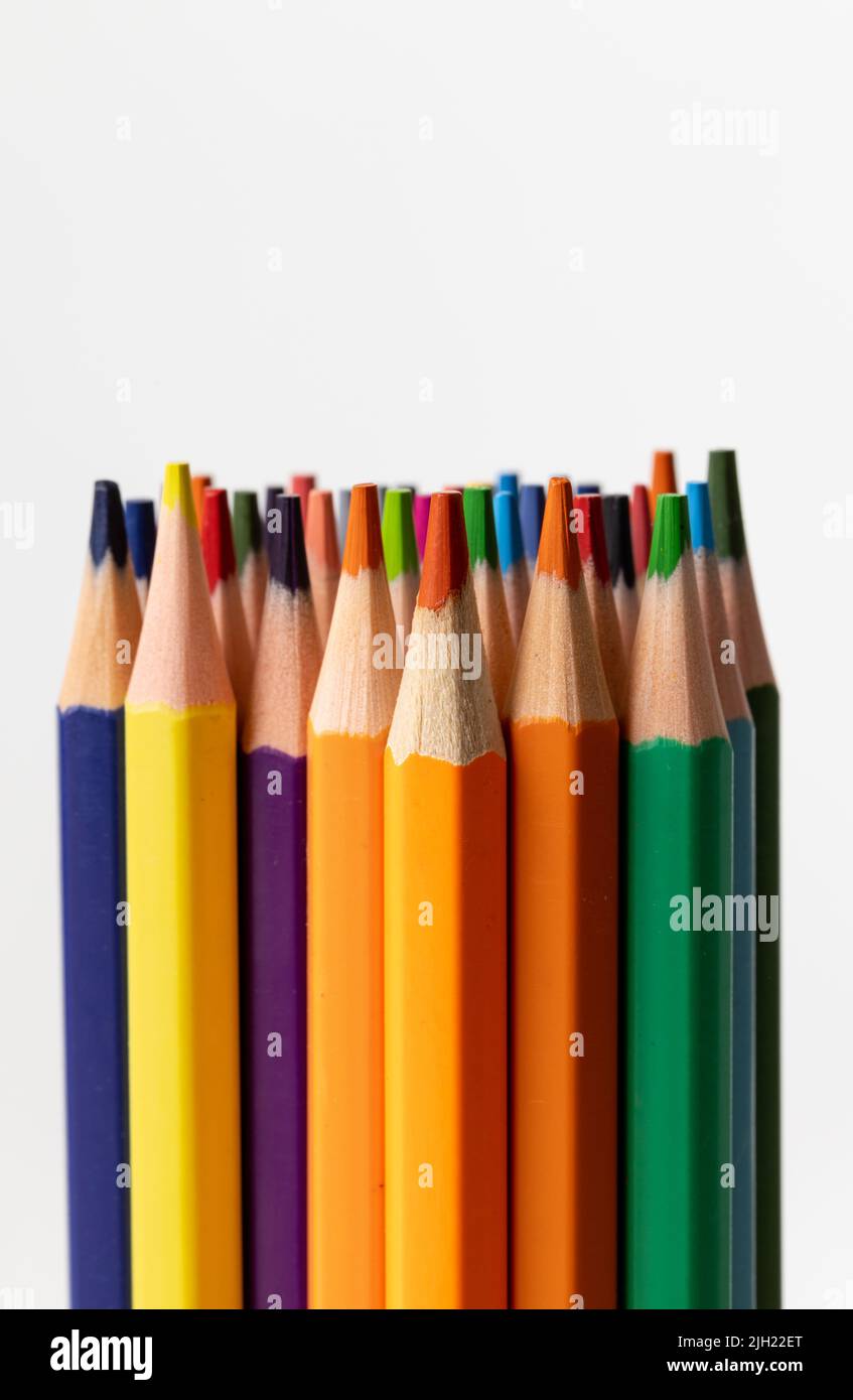 Vertical image of colorful crayons on white surface Stock Photo