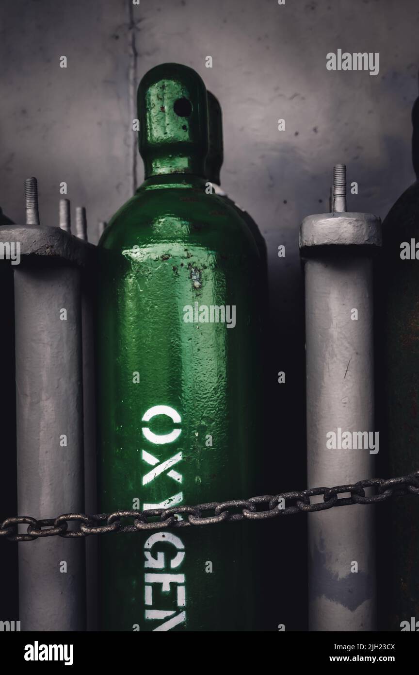 Compressed gas cylinders being stored vertically secured by a metal