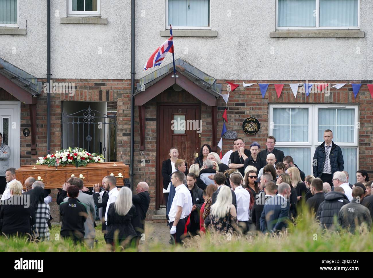 The coffin of John Steele is carried by mourners following his funeral service at his house in Larne, County Antrim. Picture date: Thursday July 14, 2022. Stock Photo
