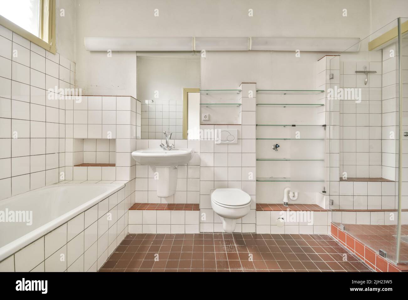 Glass partition between shower tap and wall hung toilet in modern
