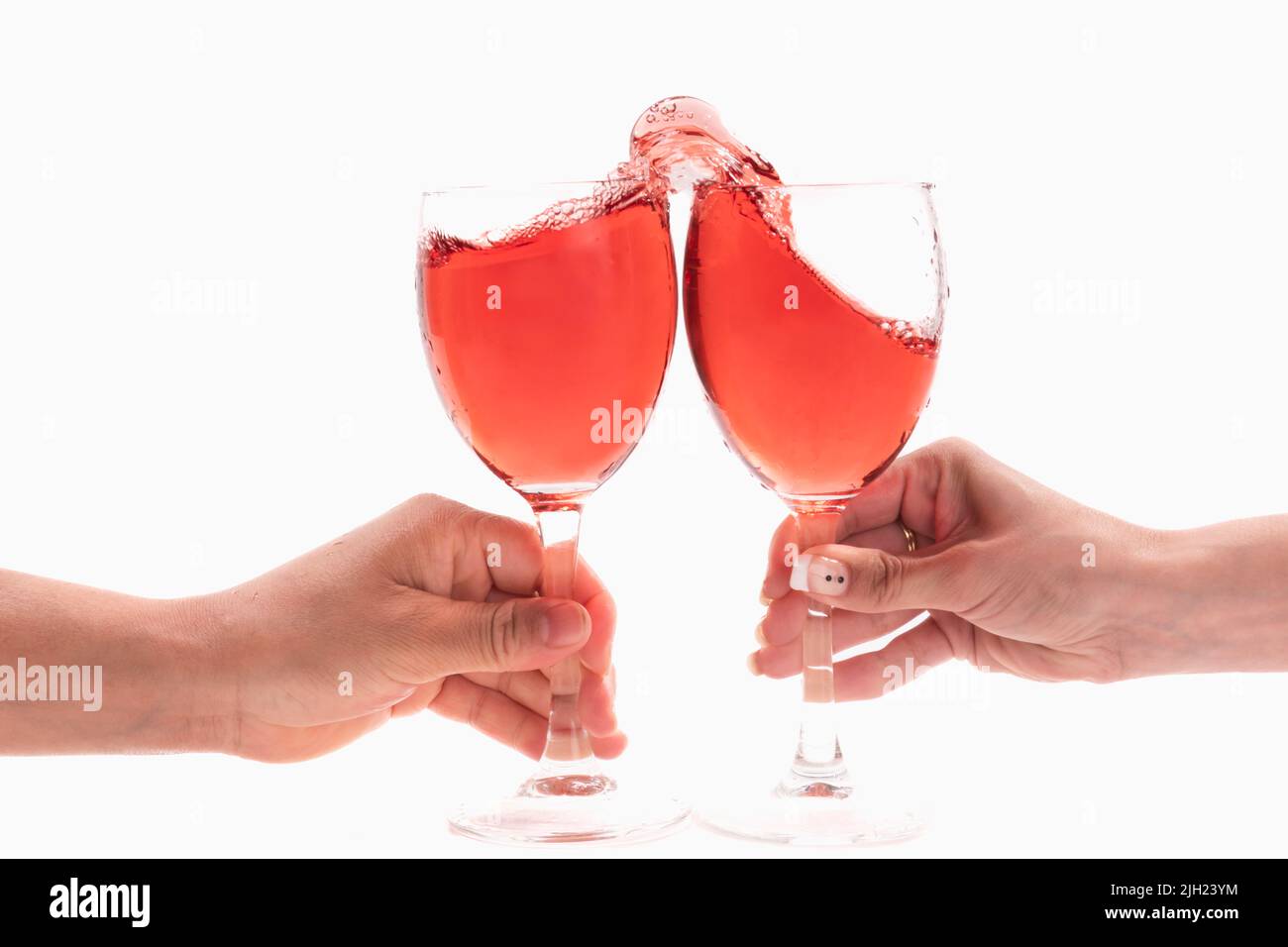 Female hands having a toast with red wine Stock Photo - Alamy
