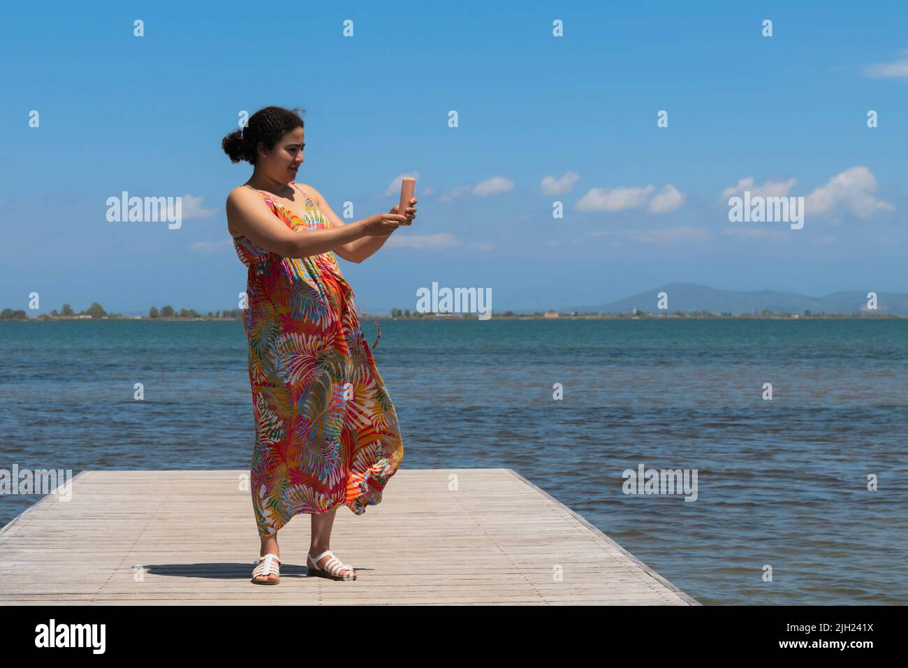 A woman on a pontoon bridge: Selective focus.  Stock Photo