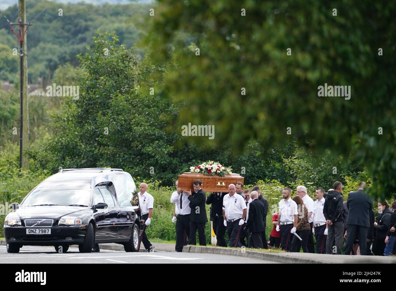 The coffin of John Steele is carried by mourners up Churchill Road, following his funeral service at his house in Larne, County Antrim. Picture date: Thursday July 14, 2022. Stock Photo