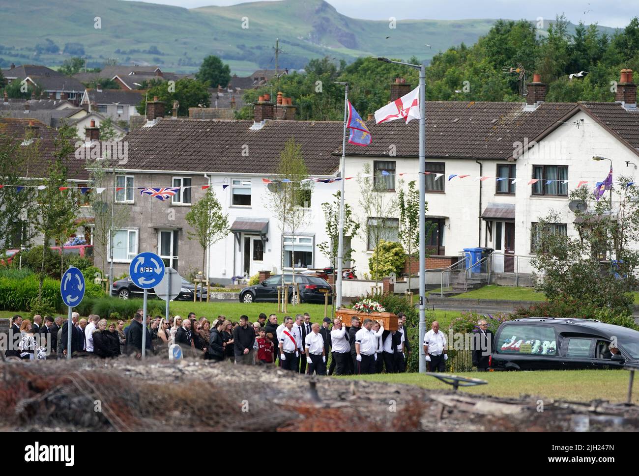 The coffin of John Steele is carried by mourners up Churchill Road, following his funeral service at his house in Larne, County Antrim. Picture date: Thursday July 14, 2022. Stock Photo