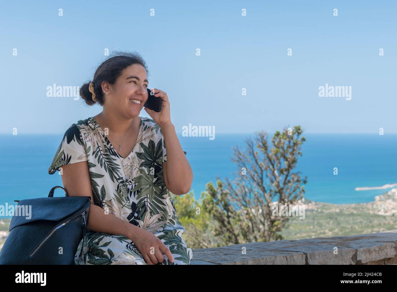 Happy looking woman talking on her phone Stock Photo