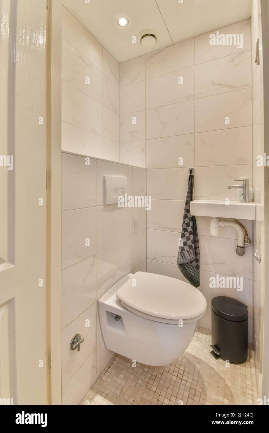 Glass partition between shower tap and wall hung toilet in modern