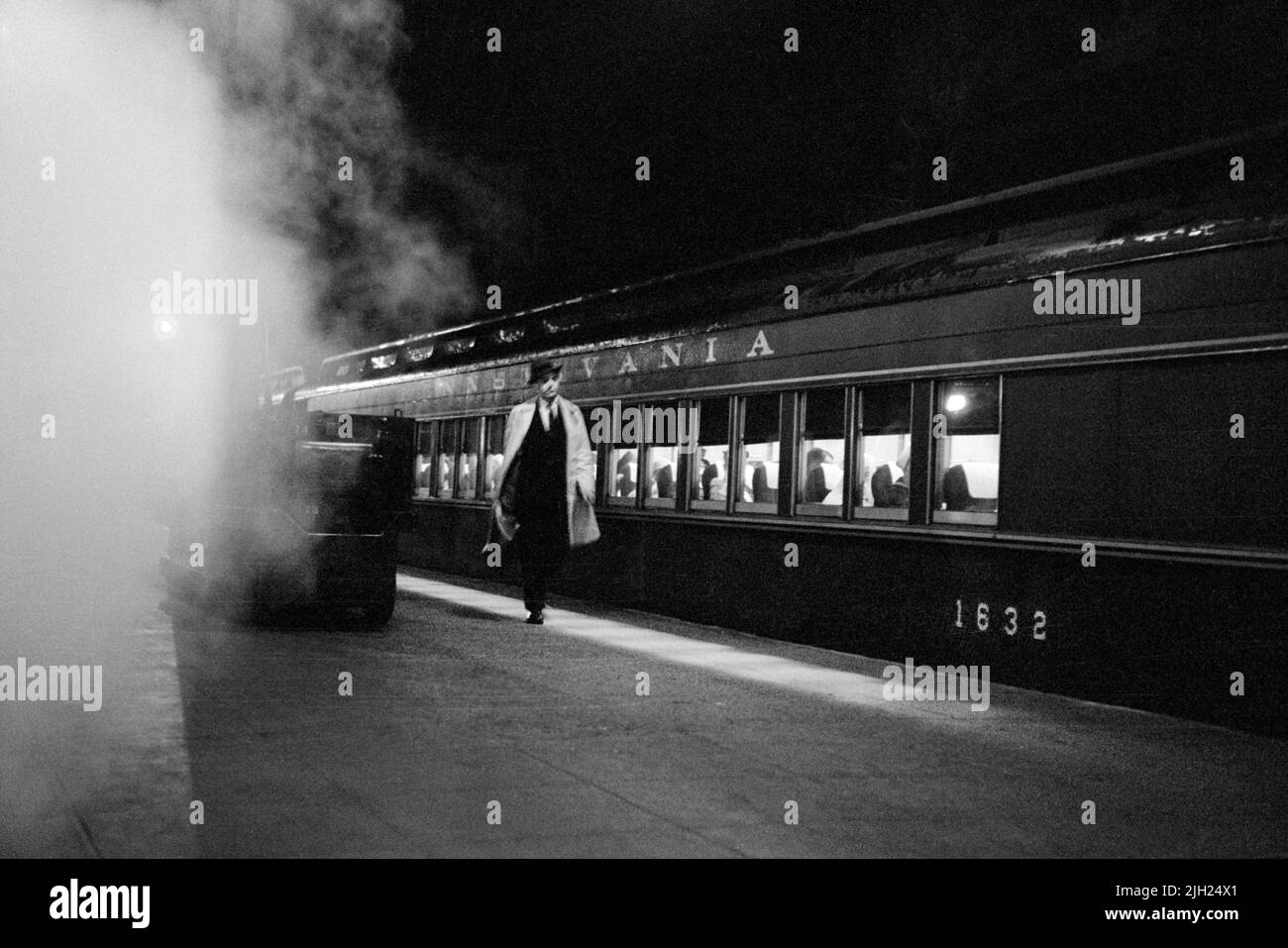 Man walking on platform next to train, Pennsylvania Station, New York City, New York, USA, Marion S. Trikosko, U.S. News & World Report Magazine Photograph Collection, April 1959 Stock Photo