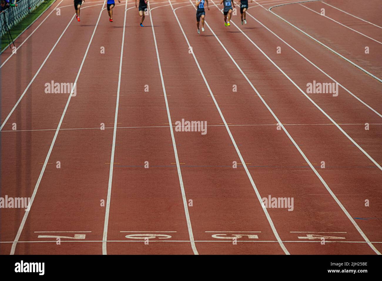 group athletes sprinters finish running at stadium Stock Photo