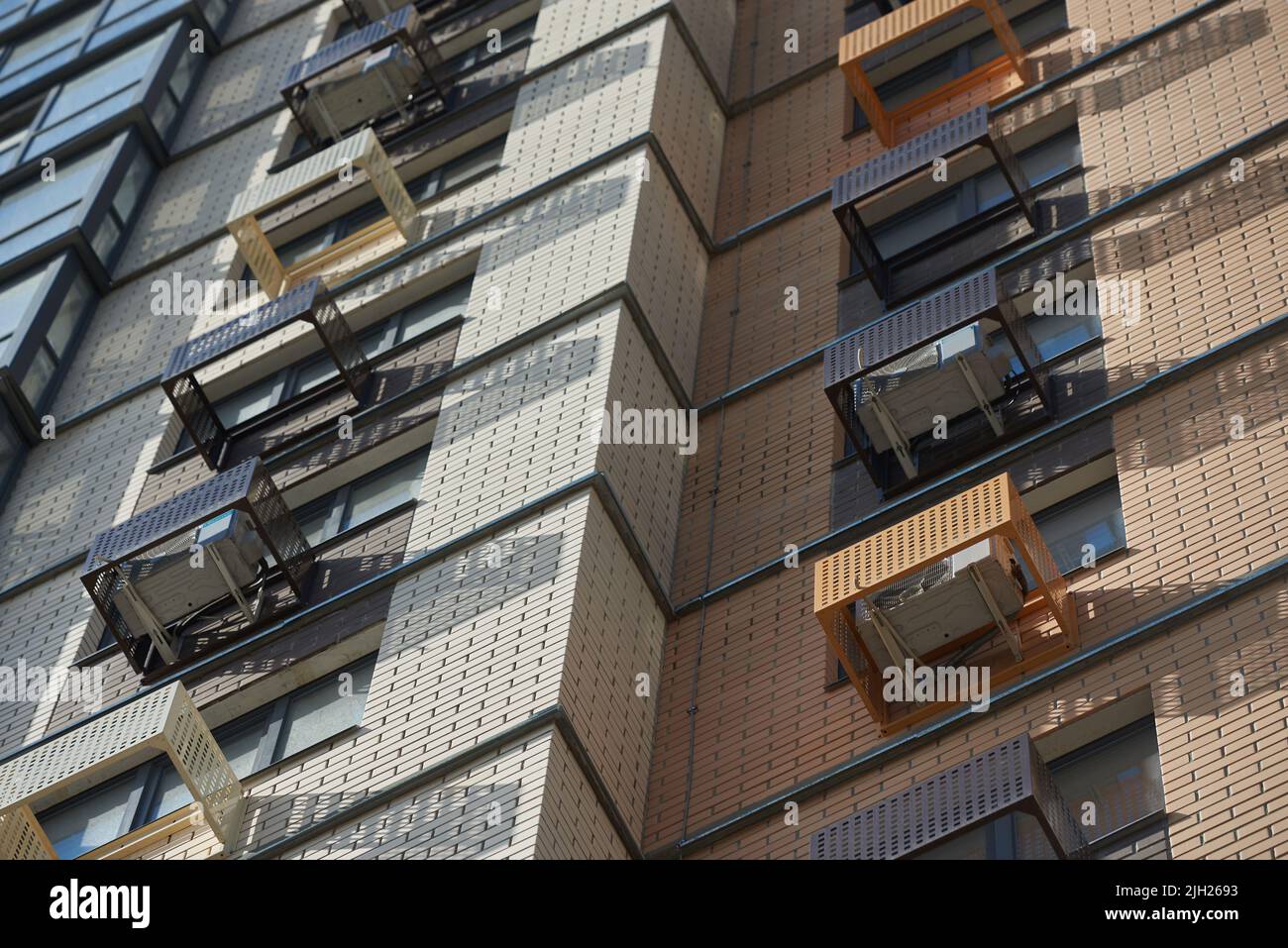 Facade of apartment building with decorative air conditioner covers