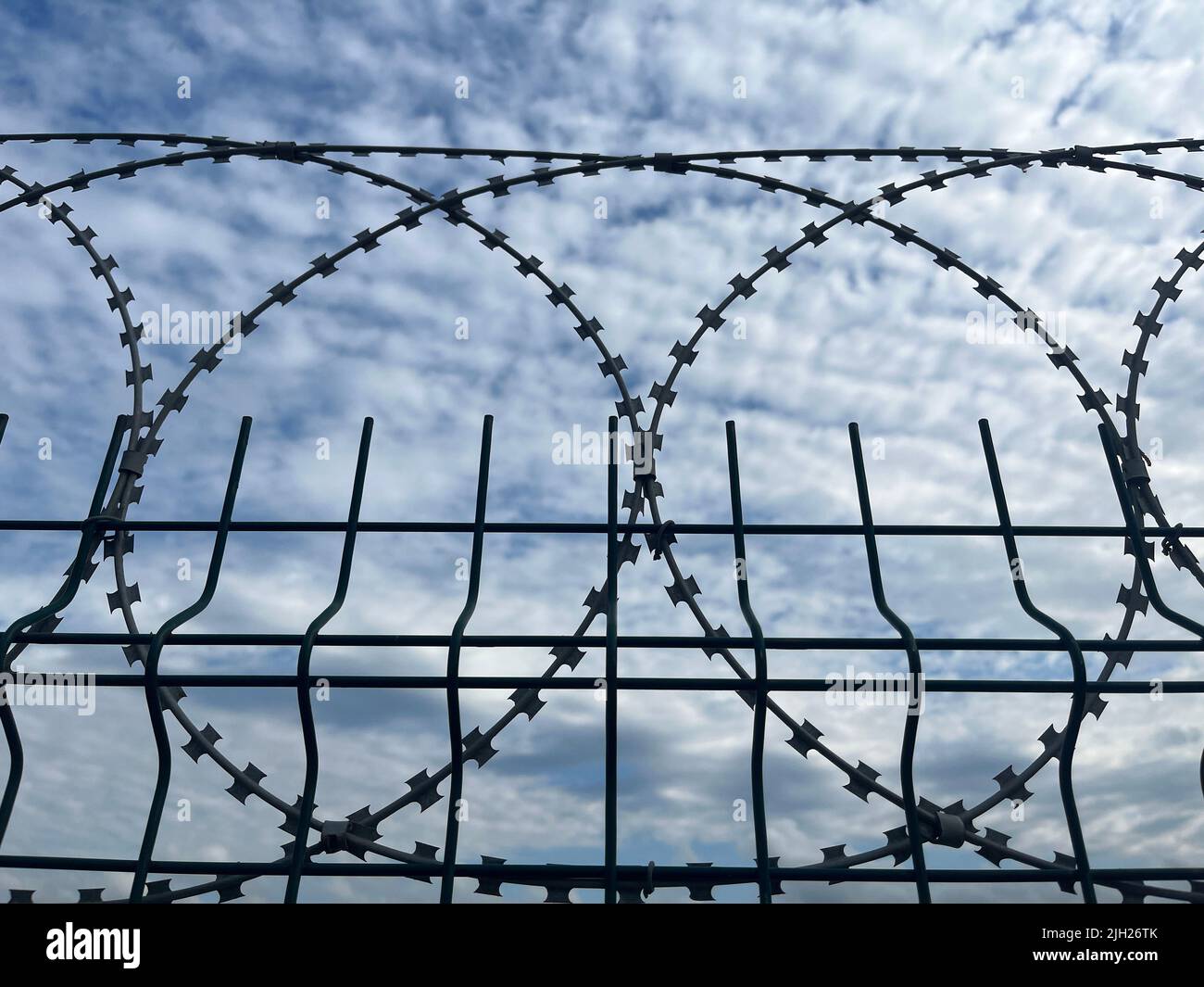 Barbed wires with sky background Stock Photo - Alamy