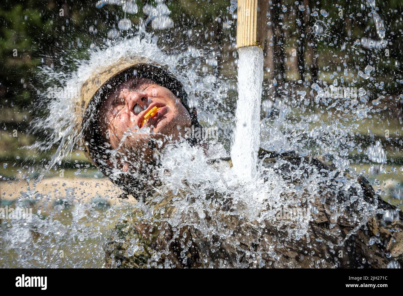 Colorado Springs, United States of America. 12 July, 2022. U.S. Air Force Academy students cool off during the Basic Cadet Training assault course at the Air Force Academy Jacks Valley, July 12, 2022 in Colorado Springs, Colorado. Basic Cadet Training is a six-week indoctrination program to transformation civilian students into military academy cadets. Credit: Justin Pacheco/US Air Force Photo/Alamy Live News Stock Photo