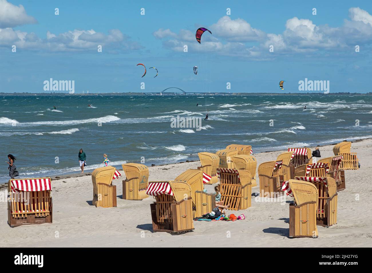 Beach chairs, kitesurfers, Fehmarnsund Bridge, Steinwarder Peninsula, Heiligenhafen, Schleswig-Holstein, Germany Stock Photo