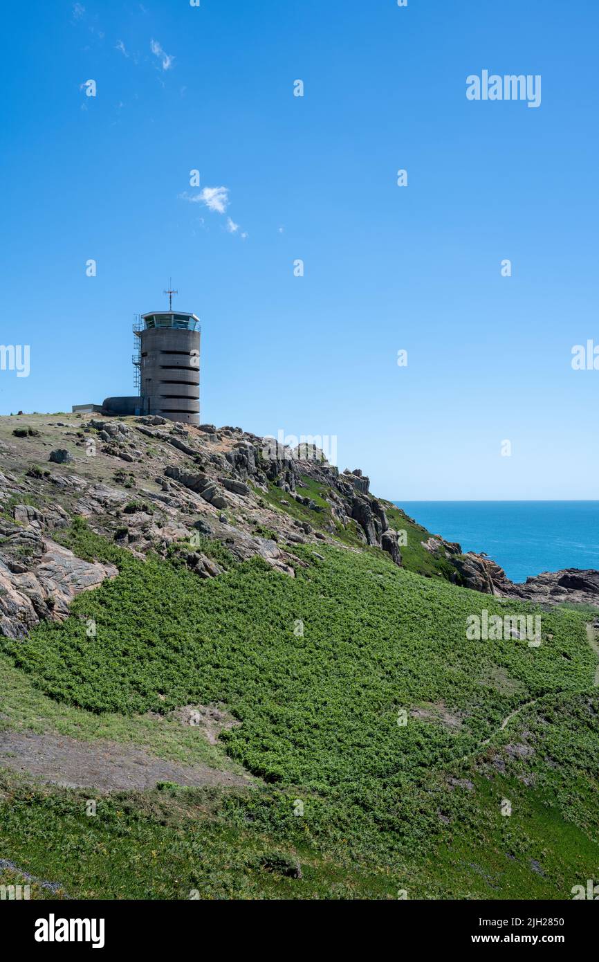 La Corbiere WW2 watchtower on the headland of St Brelade in the sout-west of the British Crown Dependency of Jersey, Channel Islands, British Isles. Stock Photo