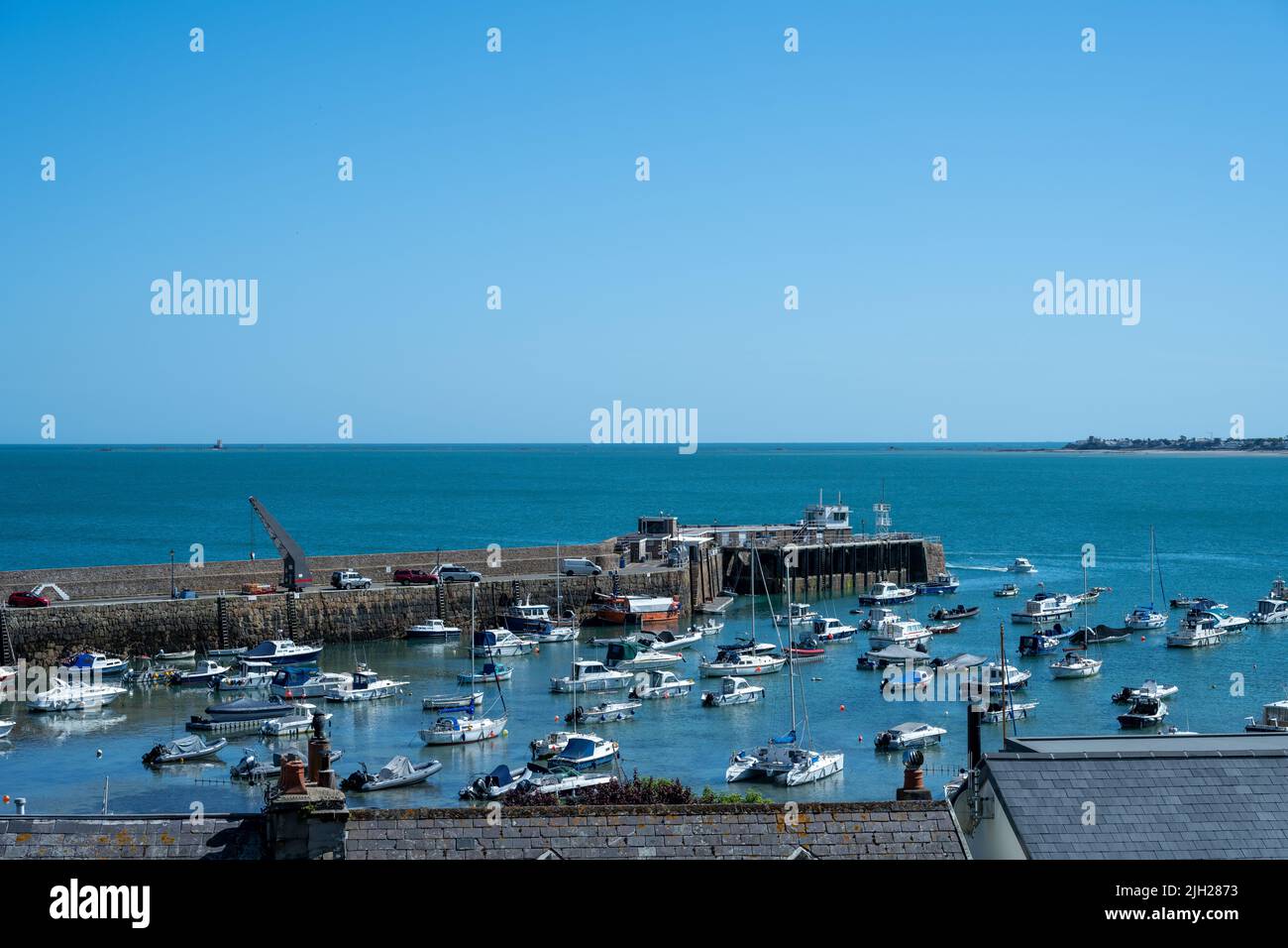 Moored fishing and pleasure boats in Gorey harbour of the British Crown Dependency of Jersey, Channel Islands, British Isles. Stock Photo