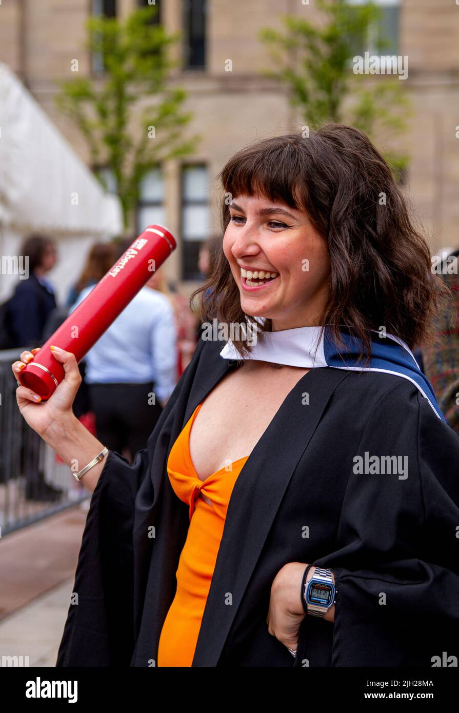 Dundee, Tayside, Scotland, UK. 14th July, 2022. Temperatures in North East Scotland surpassed 20°C due to a mix of patchy cloud, scattered showers, and sunny spells. Today is the second of three Dundee Abertay University Summer Graduation Ceremony 2022 days. Graduating Abertay University students and their families gather in Dundee City Square and the Caird Hall on Graduation Day for their belated awards. These graduation ceremonies are now taking place because Scotland has been under Coronavirus lockdown for the past two years. Credit: Dundee Photographics/Alamy Live News Stock Photo