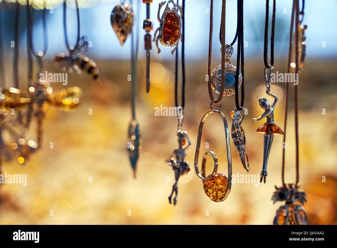 Amber jewelry pendants displayed on a shopfront in Sopot, Poland Stock Photo