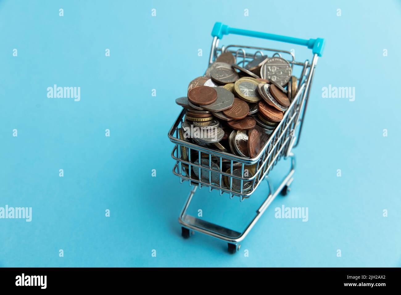 Shopping cart full of UK sterling coins. Cost of shopping concept Stock
