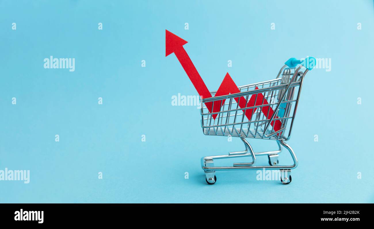 Rising cost of shopping. Shopping cart with red inflation arrow Stock