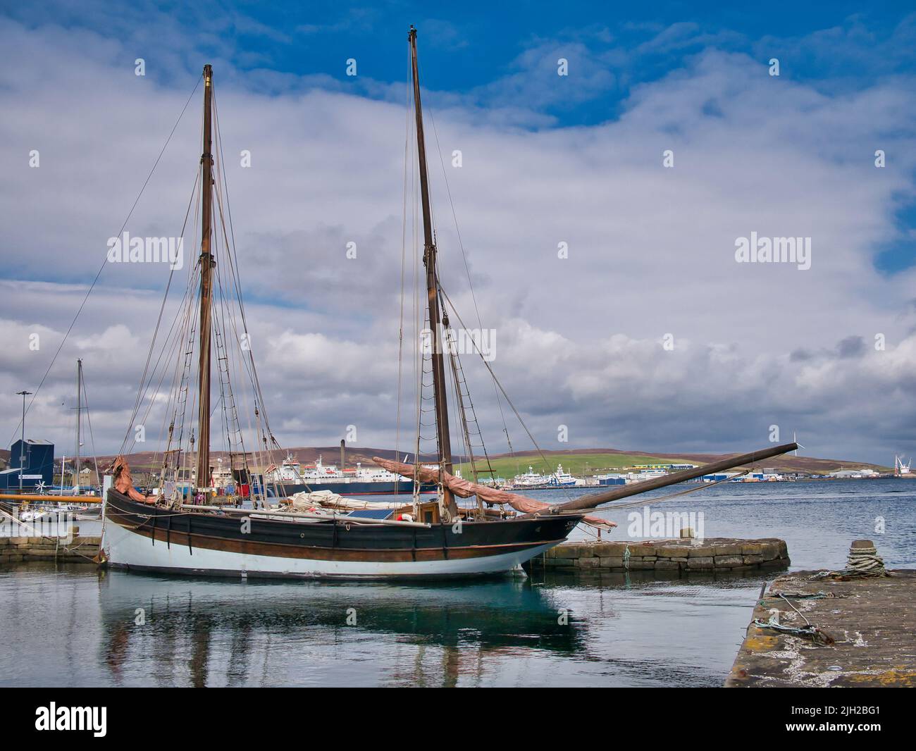 The two masted, unpowered sailing ship Swallow, registered in Gdansk and moored at Hays Dock in Lerwick, Shetland, Scotland, UK. Taken on a calm, sunn Stock Photo