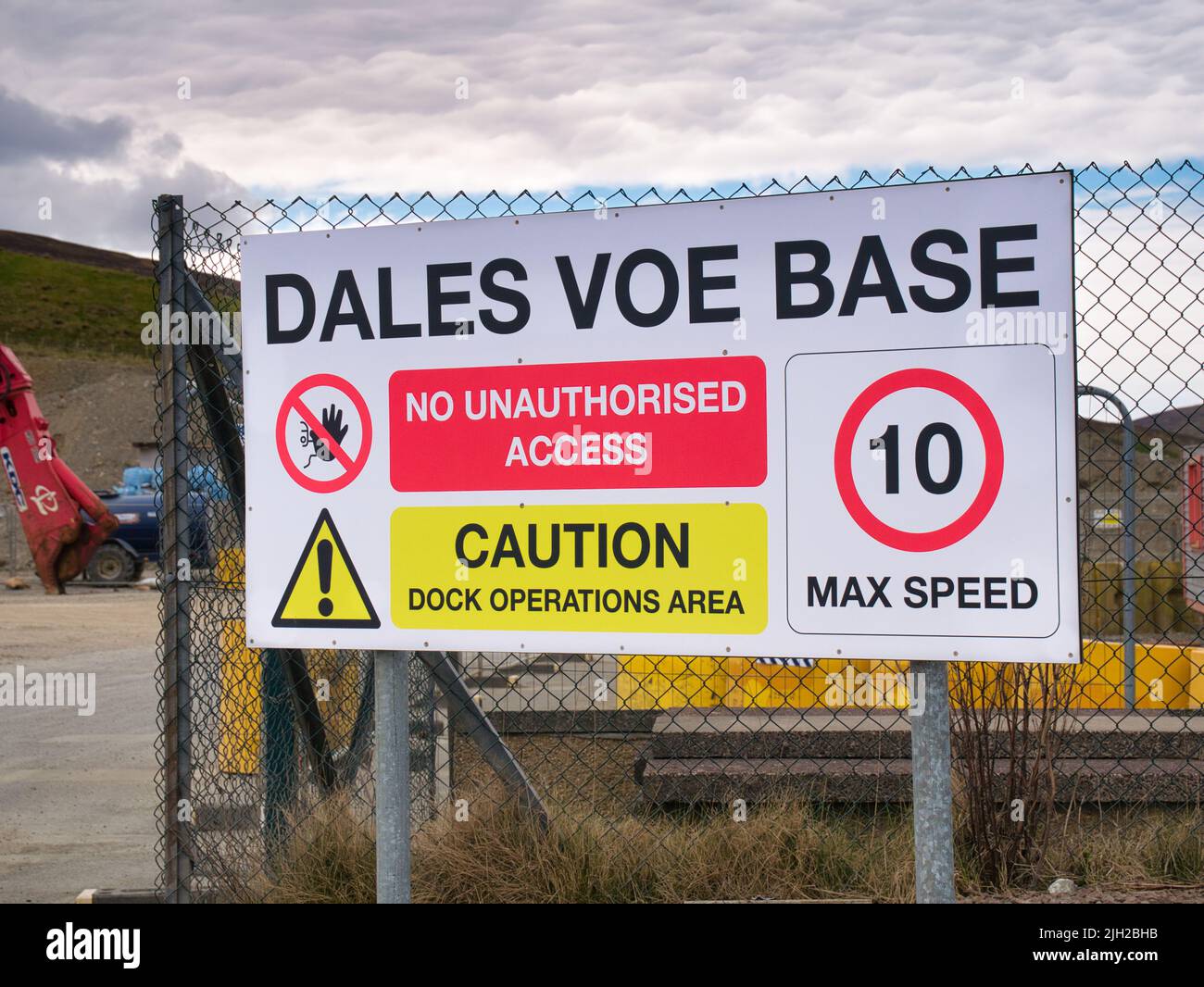 A warning sign at the entrance to the Dales Voe Base, the UK's Ultra-Deep-Water decommissioning facility for oil and gas facilities from the North Sea Stock Photo