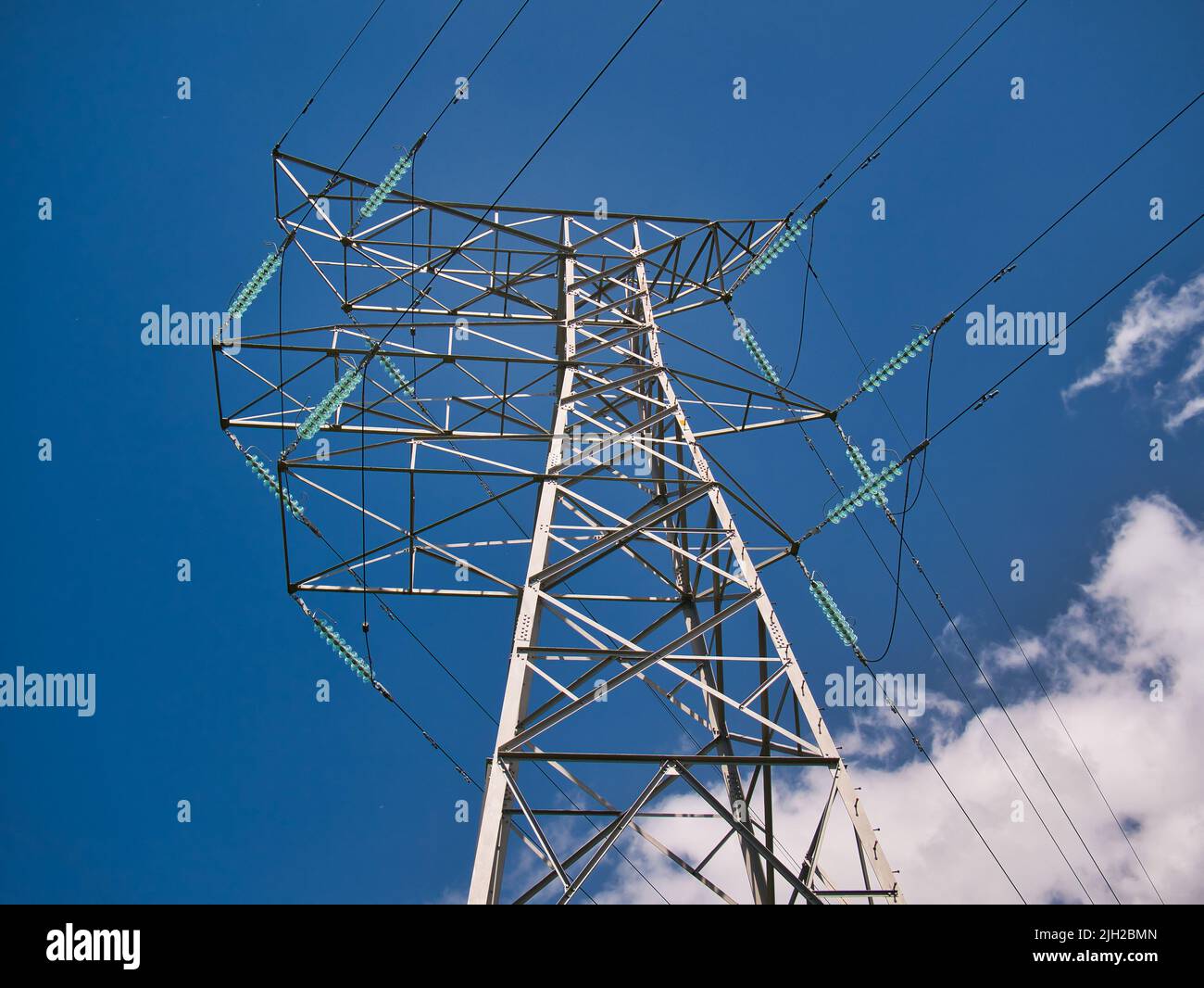 An electricity supply pylon delivering power through the UK national grid showing power cables, isolators and other equipment. Stock Photo