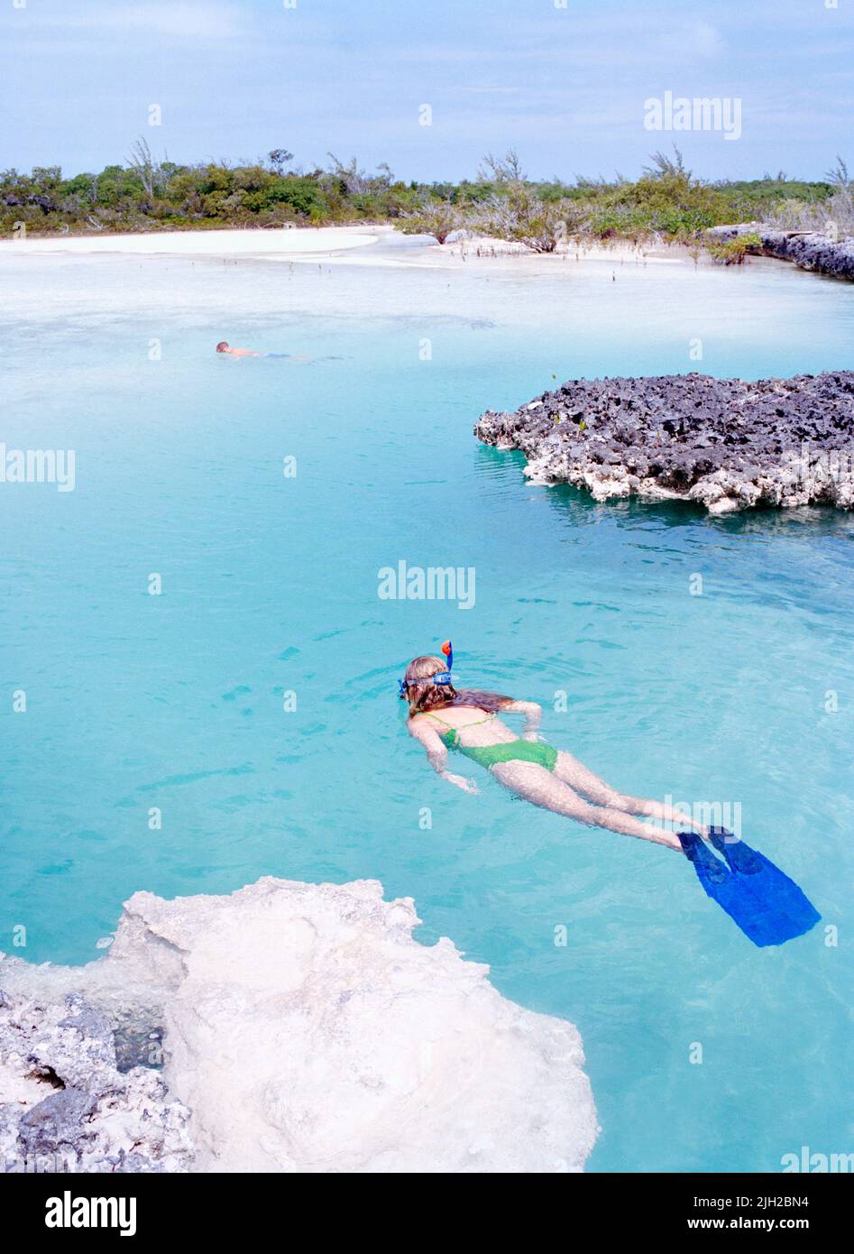 Guests from Tiamo Resort snorkel at the entrance to 'The Crack'. A popular snorkling destination near the resort. South Bight Waterway, Bahamas. Stock Photo