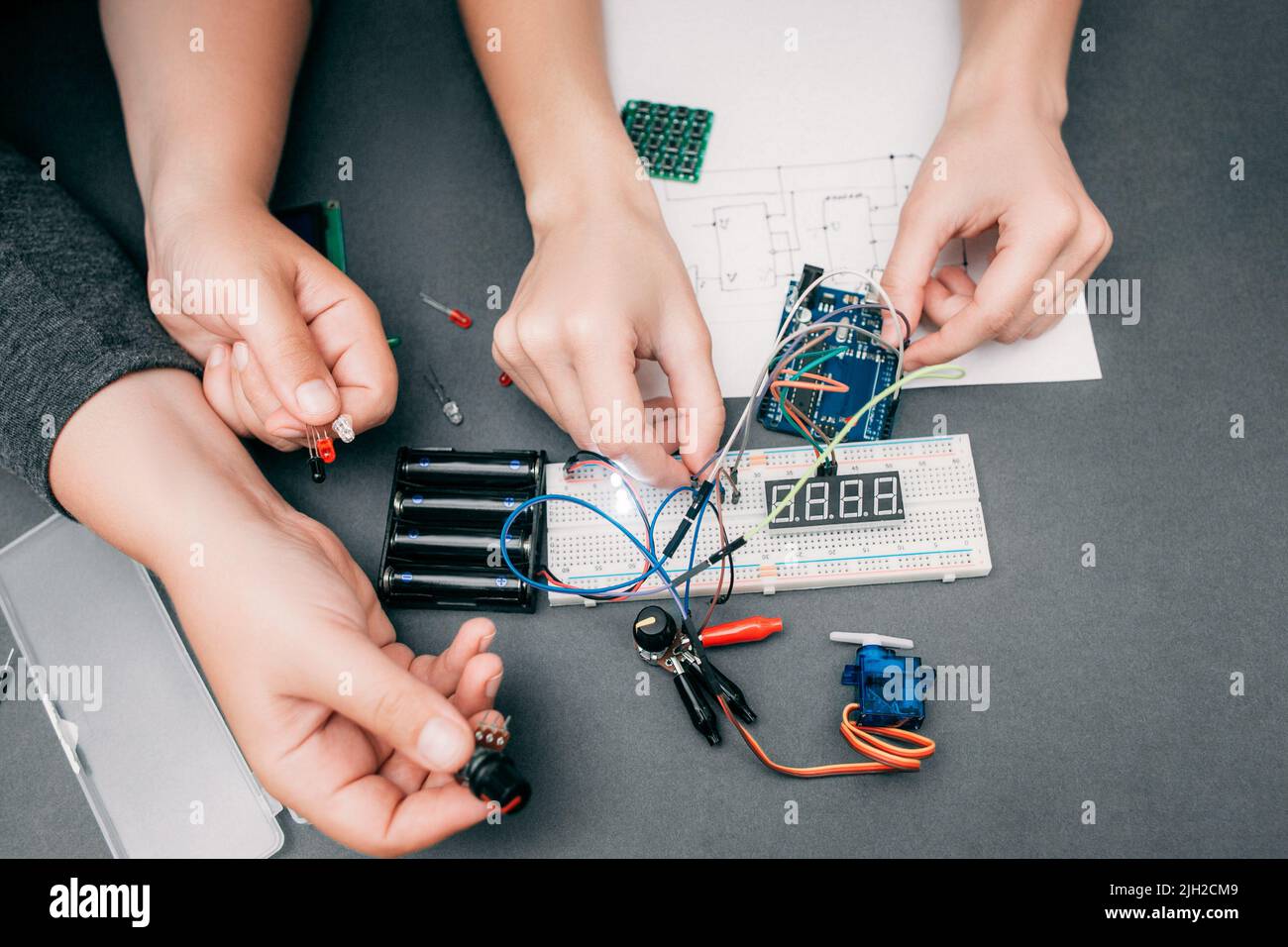 Engineers hands connecting electronic components Stock Photo