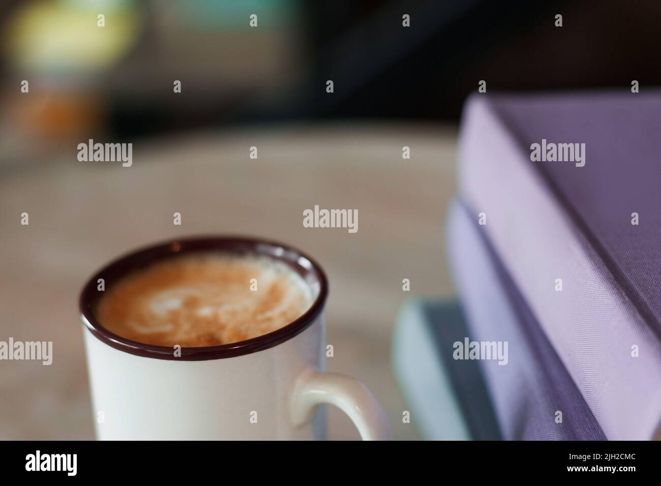 Cup of coffee with purple folders, free space Stock Photo