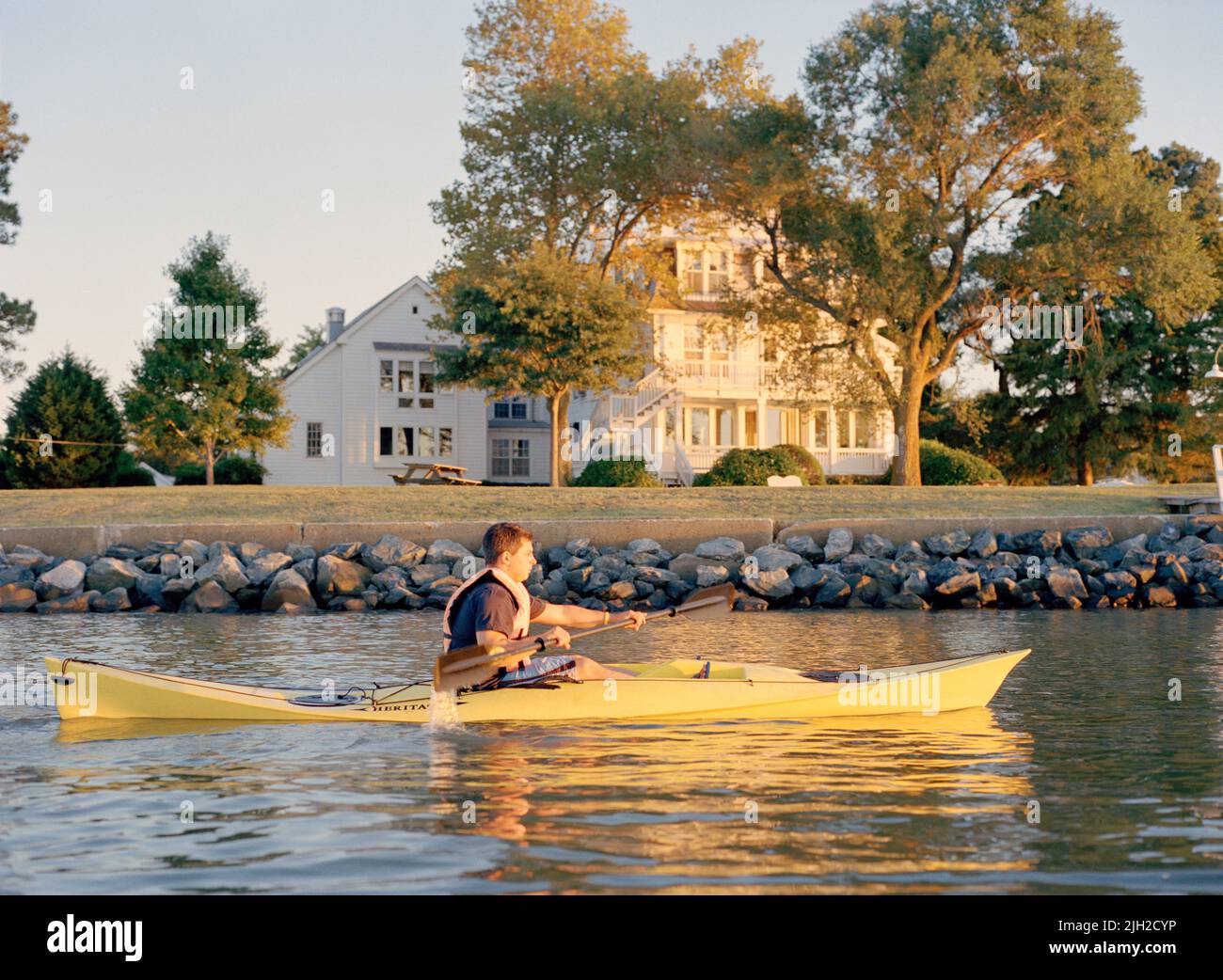 A man kayaks in Chesapeake Bay at sunset. St. Michaels, Maryland Stock