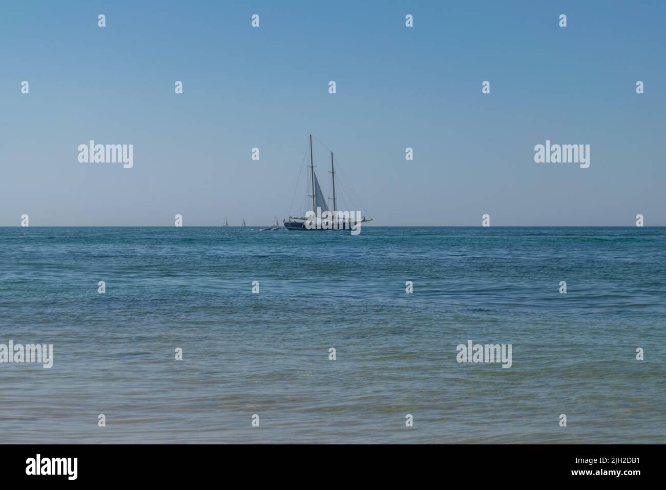 Touristic boats cruising on summer time in the ocean. Boats on the sea. Nautical activities, tourism on coastal locations. Boat tours. Stock Photo