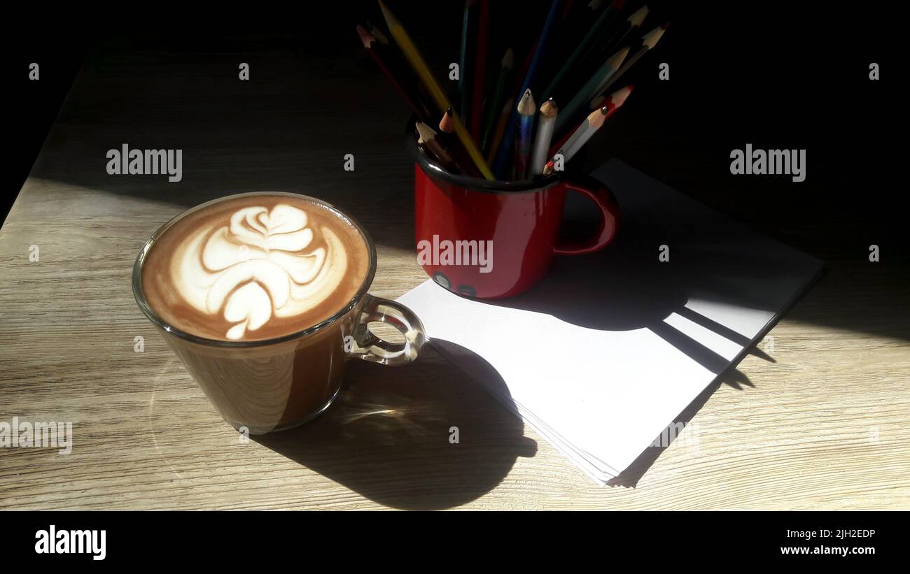 Cocoa, latte art and crayons Stock Photo